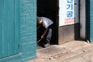 A technician performing an inspection during a sliding door repair appointment.